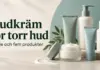 Hudkräm för torr hud: guide och fem produkter att känna till Fem omärkta hudvårdsförpackningar och en klick kräm i ljusa, gröna och blå toner intill texten ”Hudkräm för torr hud – Guide och fem produkter”.